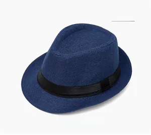 Detail view of navy blue straw fedora hat with black ribbon band on white background