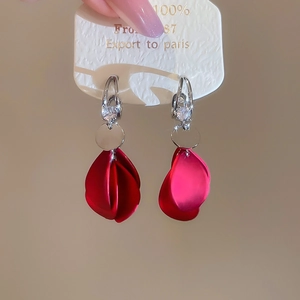 Close-up of red petal tassel earrings with acrylic zircon and silver needle finish