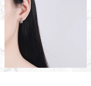 Close-up of elegant silver chain ear cuffs featuring micro-pave cubic zirconia stones