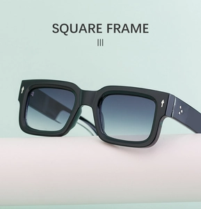 Detail of vintage square frame sunglasses with grey gradient lenses on a pedestal
