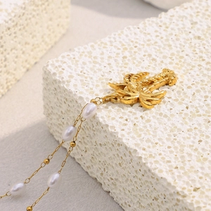 Detail of 18K gold plated stainless steel palm tree pendant with small white pearls