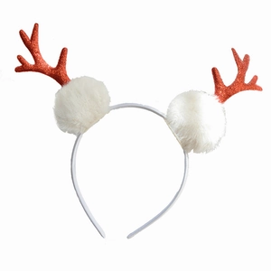 Sparkly red antler Christmas headband with white plush balls on a clean white background