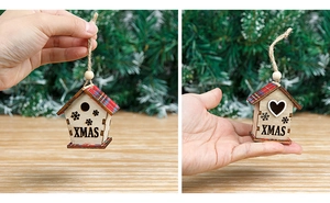 Macro detail of wooden Christmas house ornament with red plaid roof and XMAS engraving