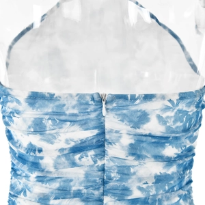 Detail of blue tie-dye mesh dress featuring ruched fabric and hidden back zipper