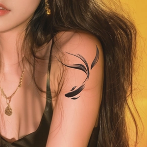 Waterproof temporary tattoo featuring artistic black ink koi fish design on arm shoulder