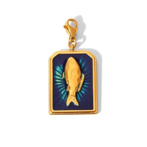 Detail of golden rectangular pendant with blue enamel fish relief and lobster clasp