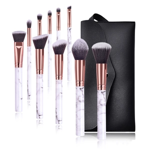 10-piece marble makeup brush set with rose gold ferrules and a black storage bag