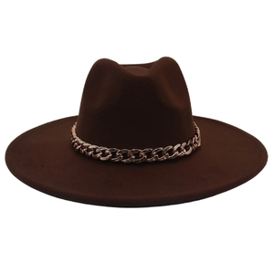 Detail of rose gold chain on a wide brim dark brown fedora hat with felt texture
