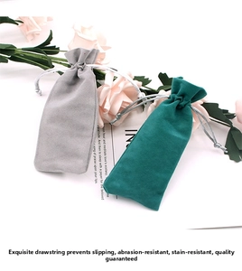 Detail view of grey and cyan velvet drawstring pouches for jewelry and small gift storage