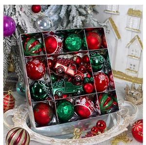 Detailed view of red and green festive Christmas ornaments set in a silver display box