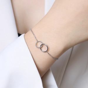 Silver titanium steel bracelet featuring interlocking double rings on a model's wrist