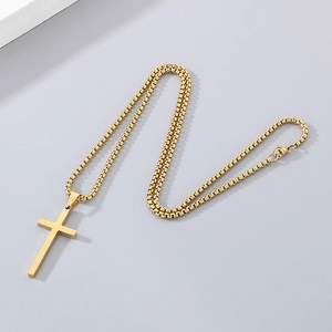 Detailed view of a golden stainless steel cross pendant with a classic box chain necklace
