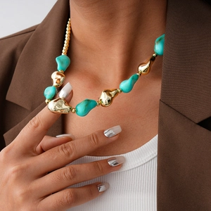 Detailed view of bohemian turquoise bead necklace with irregular gold metal pieces