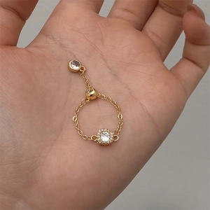 Elegant gold chain ring with a square-cut zircon and small round gem charm