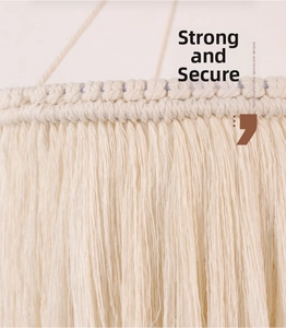 Close-up of handmade beige macrame lamp shade featuring woven cotton knots and long tassels