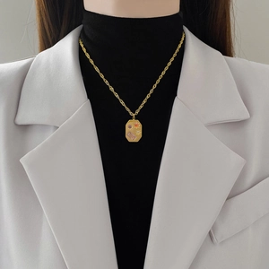 Golden titanium steel necklace with star octagon pendant worn on professional model