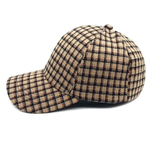 Detail shot of brown and black plaid pattern texture on the structured baseball cap