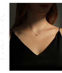Elegant silver necklace with a brilliant four-prong solitaire pendant on a model