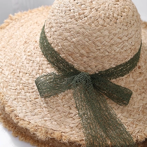 Handmade raffia sun hat with dark green mesh ribbon bow and frayed edge brim for summer