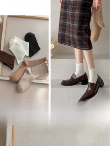 Detail of ruffled cuff cotton socks shown flat and styled with loafers for women