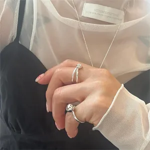Minimalist S925 sterling silver knotted ring and beaded jewelry set worn by a model
