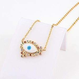Detail of 18k gold heart evil eye pendant necklace with colorful cubic zirconia