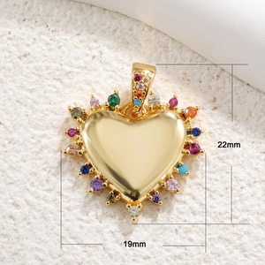 Detail view of 19mm x 22mm gold heart pendant with colorful zircon stones and crown detail