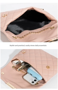 Detail shot of the pink quilted crossbody bag showing spacious interior and golden chain