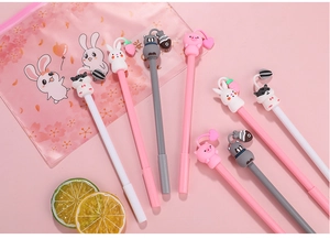 Close-up of cute cartoon animal gel pens with silicone rabbit and cat charms in a pouch