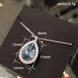 Classic silver necklace with blue teardrop crystal pendant and halo of small diamonds
