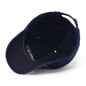 Detail of blue baseball cap interior showing six-panel stitch and adjustable metal buckle