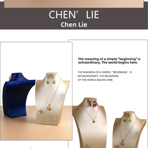 Detailed view of jewelry display busts for necklaces and earrings in blue and gold