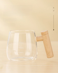 Detail of 400ml borosilicate glass stirring mug with scale and wood texture handle