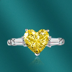 Close-up of luxury heart-shaped yellow gemstone ring with side baguette-cut stones