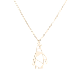 Detail of a minimalist gold origami penguin cutout pendant on a delicate O-chain necklace