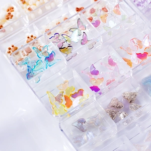 Multi-grid box with colorful butterfly and heart nail art charms in various textures