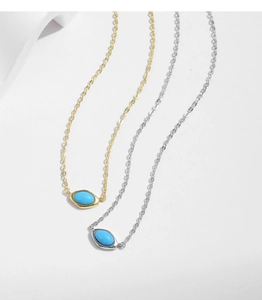Detailed comparison of gold and silver irregular turquoise pendant necklaces on white base