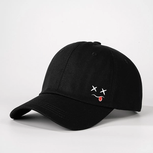 Detailed side view of black cotton baseball cap with white X-eye tongue embroidery