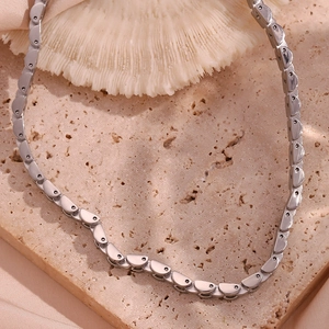 Close-up of silver-tone polished stainless steel 6mm D-link choker chain on stone