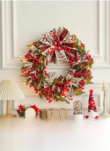 50cm Christmas wreath with red berries, plaid bow and warm LED lights on a white fireplace