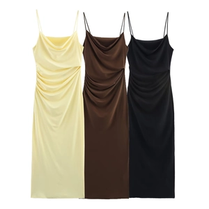 Detailed view of satin slip dresses in yellow, brown, and black with side ruched design