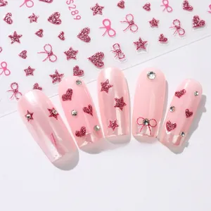 Detail of pink glitter star and bow nail art stickers model S289 on manicure