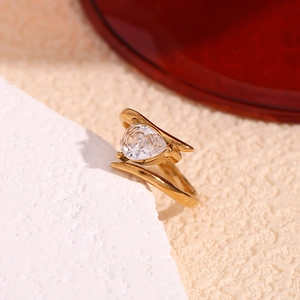 Detail of 18K gold plated wing ring featuring a pear-shaped white zircon gemstone setting