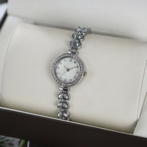 Detailed view of silver mermaid bracelet watch with leaf rhinestones on watch pillow