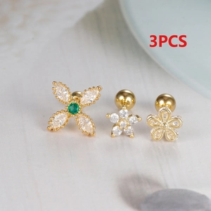 Macro shot of 3pcs gold-plated surgical steel ear studs with zircon flower and star designs