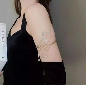 Close-up of golden multi-layer arm cuff with shimmering rhinestones on a female model