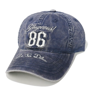 Detailed close-up of vintage blue denim baseball cap with 86 Gorgeous white embroidery