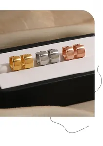 Three pairs of brushed stainless steel hoop earrings in gold, silver, and rose gold finish