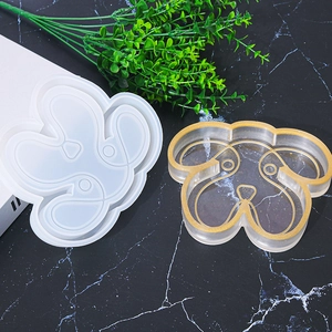 Detail of dog-shaped silicone mold with glittery resin craft tray on marble