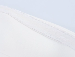 Close-up of precise stitching and Velcro texture on the white commuter suit's fabric